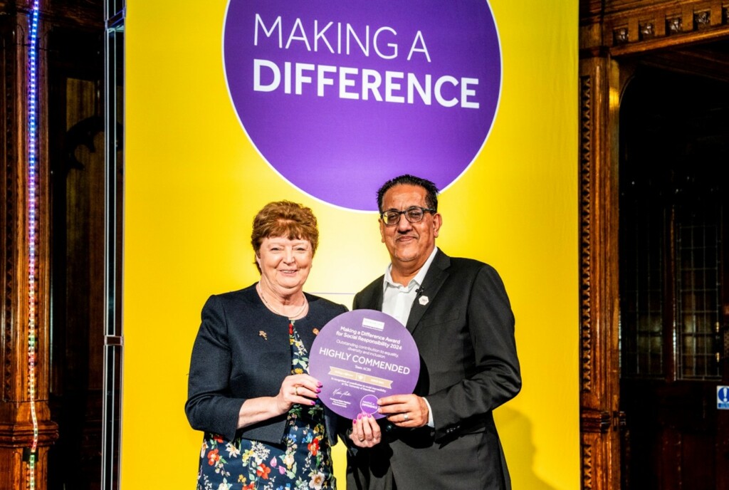 Kathy Cowell, MFT Chairman accepting the award on behalf of Team ACES, pictured with Nazir Afzal OBE, University of Manchester Chancellor